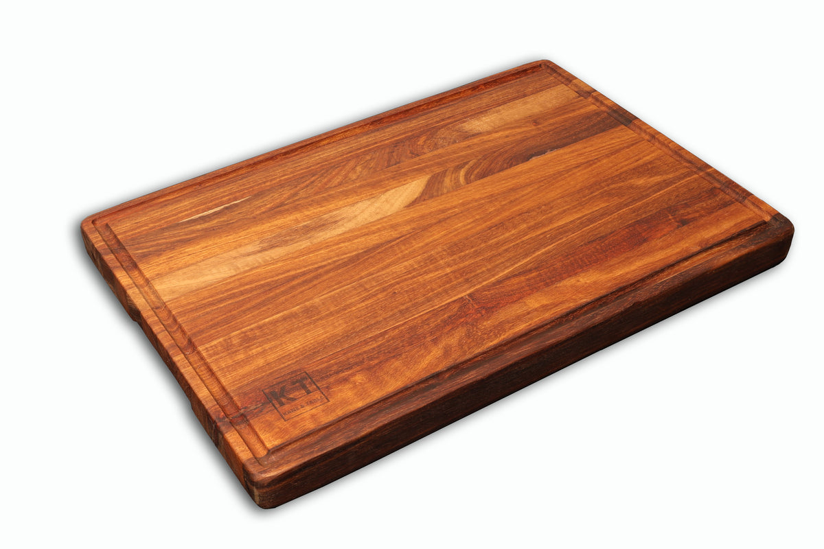 Medium handcrafted wooden chopping block by Kane and Table, shown at an angle