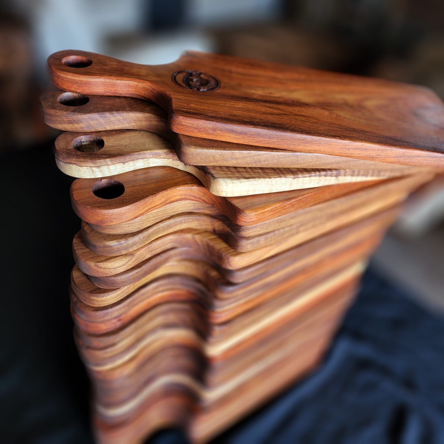 Stack of handcrafted Kane and Table wooden serving boards